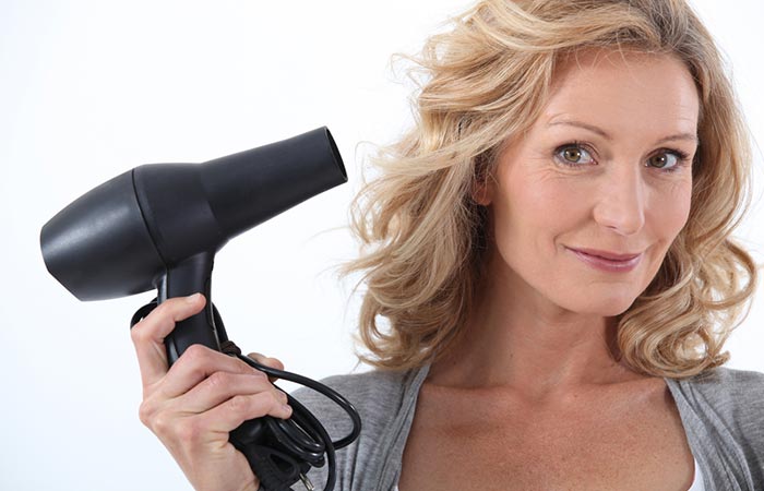 Woman using blow dryer smartly to style baby hair
