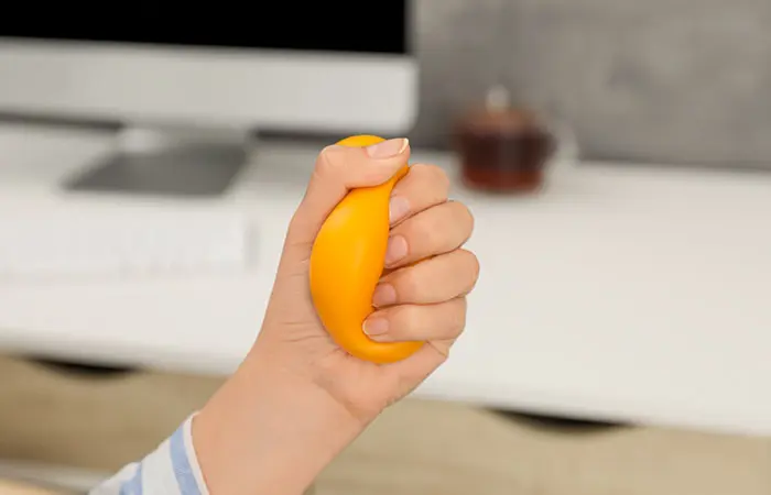 A man squeezing a stress ball