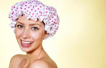 Woman in shower cap with baking soda on hair