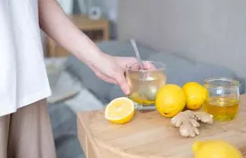 Man taking honey water with lemon and ginger before bed for good sleep