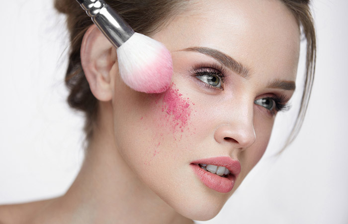Apply pink blush powder to cheeks for a flushed look