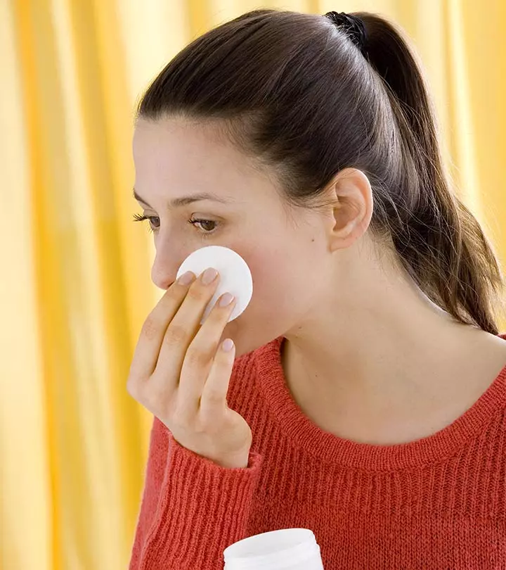 A girl applying hydrogen peroxide on her wound