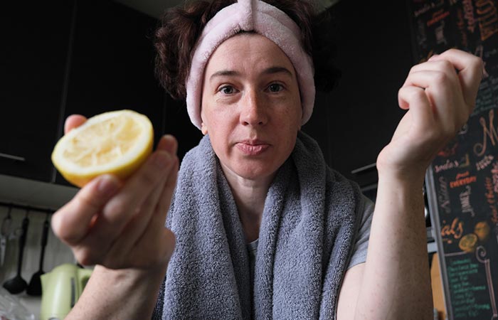 Woman using lemon juice for skincare