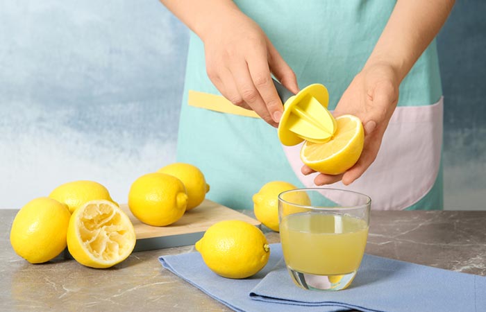 Woman squeezing out lemon juice to make hair spray