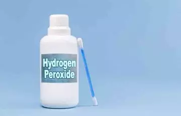Bottle of hydrogen peroxide with an earbud