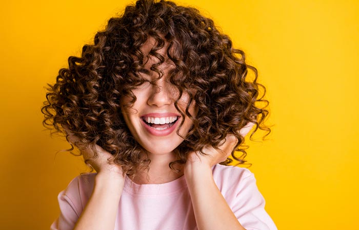 Woman using hair cream for curly hair