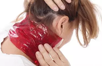 Woman applying cold compress on hickey