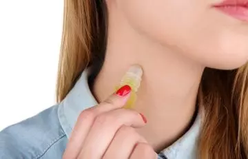Woman applying essential oil on the hickey