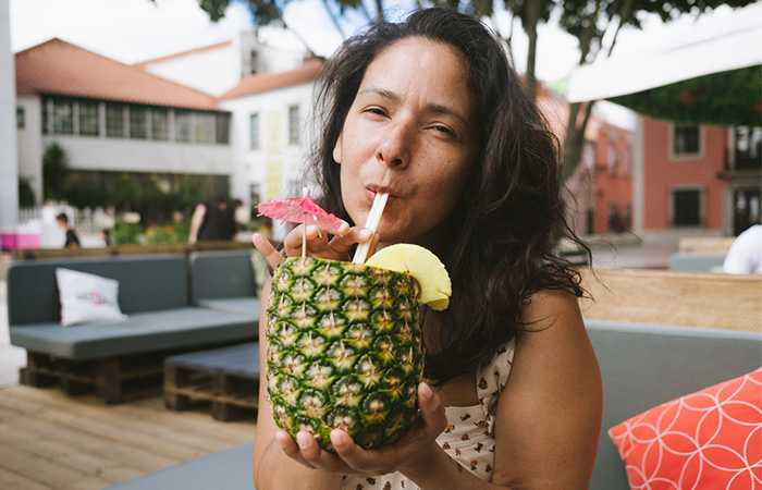 Woman drinking fresh pineapple juice for managing constipation