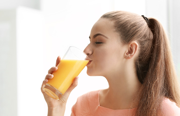 Woman drinking pineapple juice for constipation