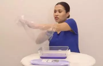 Wrap the wax-coated hand with plastic