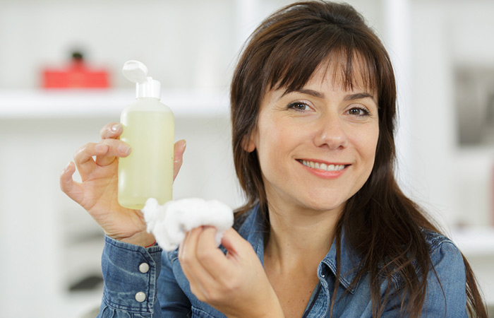 Woman holding hydrogen peroxide and cotton