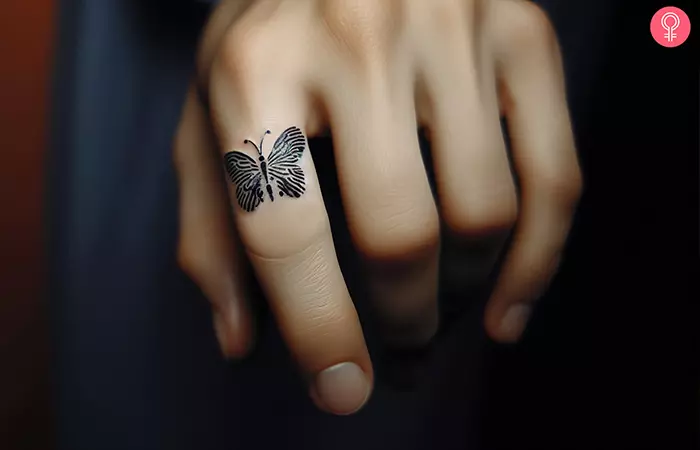 A minimalist butterfly made with fingerprint wings on the index finger