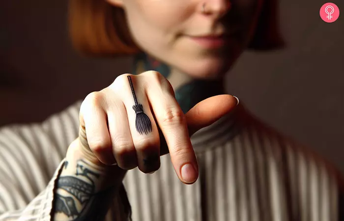 A minimalist hat outline tattoo on the base of the index finger
