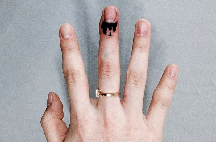 Dripping nails tiny finger tattoo
