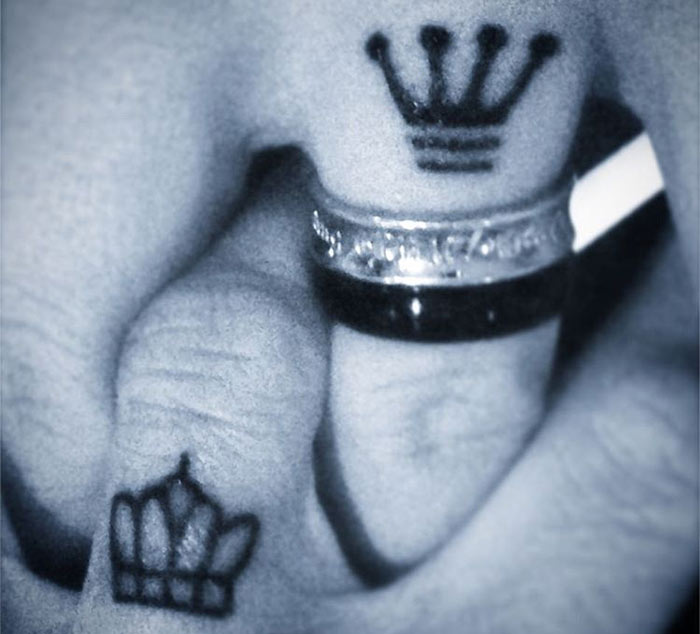 Crowning glory tiny finger tattoo