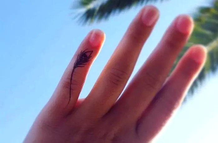 Delicate feather tiny finger tattoo
