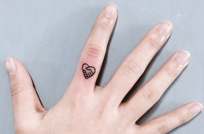 Tiny heart finger tattoo