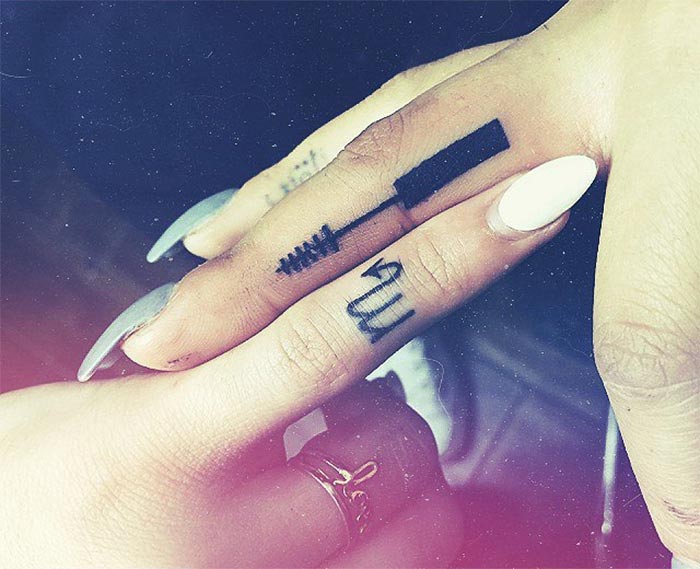 Zodiac sign tiny finger tattoo