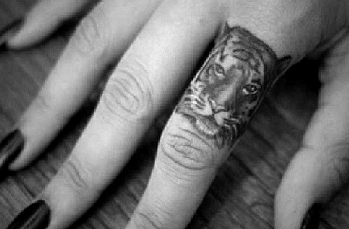 Tiny tiger finger tattoo