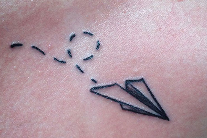 Paper airplane tiny tattoo