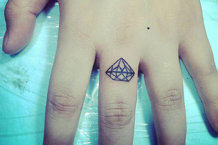 Diamond tiny tattoo on finger