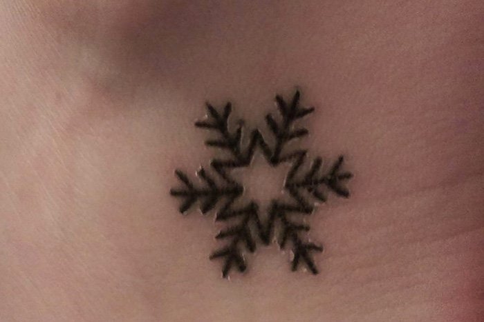 Snowflake tiny tattoo