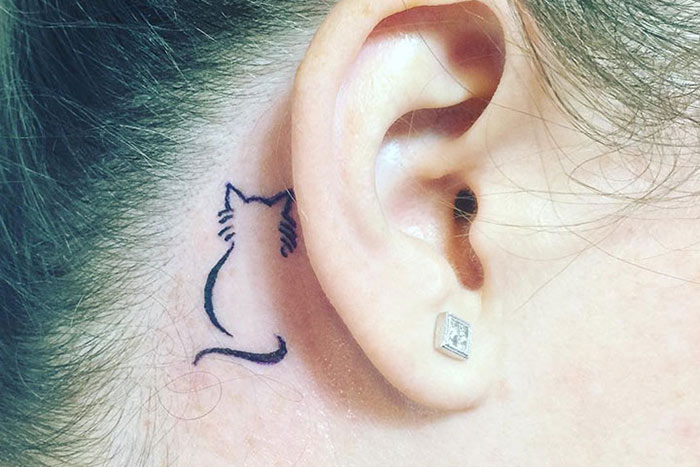 Behind the ear tiny tattoo of cat