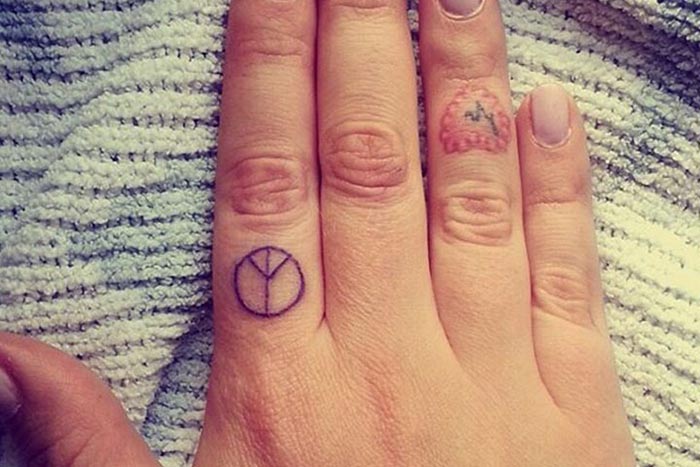 Tiny peace symbol tattoo