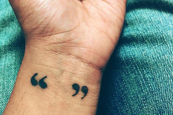 Tiny quote-unquote mark tattoo