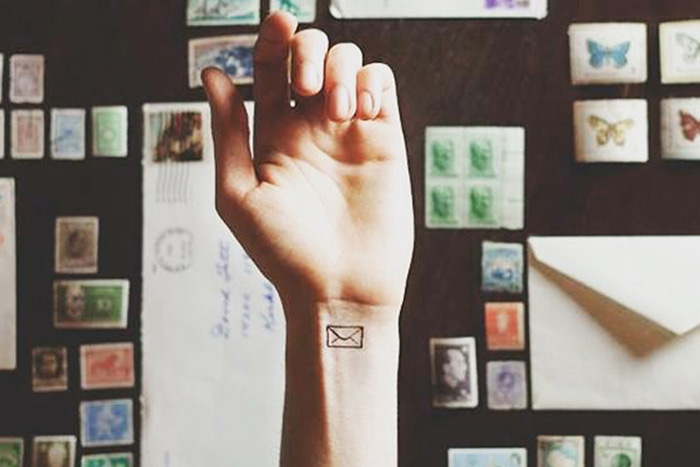 Tiny envelope tattoo