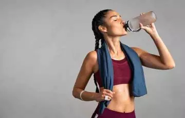 Woman drinking cold water after a workout