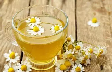 A cup of chamomile tea as a remedy to manage redness on the face