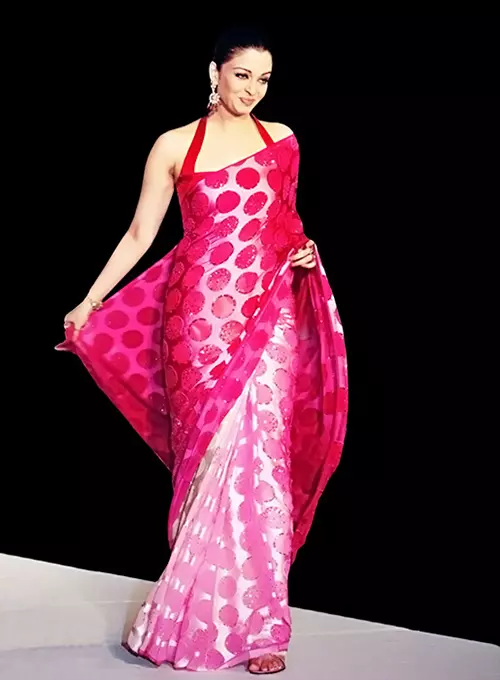 Aishwarya Rai in a glossy pink satin saree with halter neck blouse