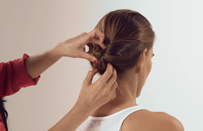 Step 9 of how to do a low bun