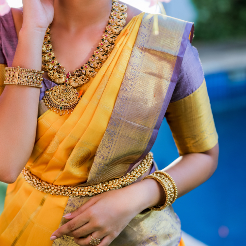 A woman wearing a yellow and blue Peshwai Paithani saree