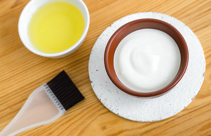 Yogurt and olive oil in a bowl each, along with a hair brush