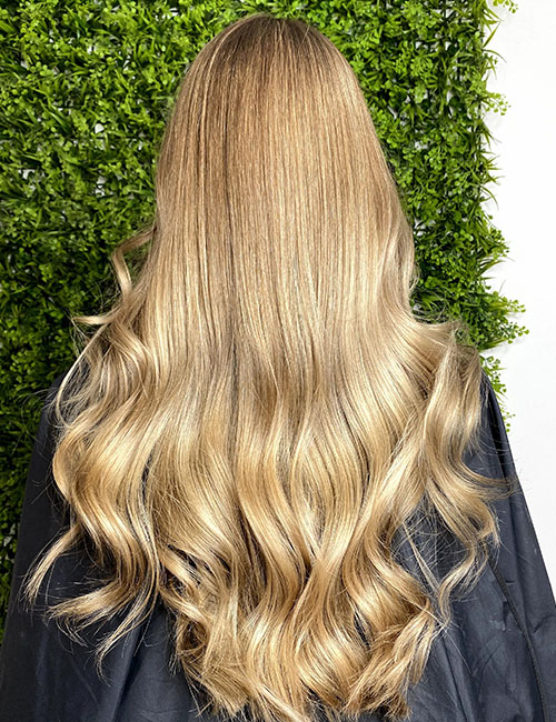A beautiful warm blonde ombre on long waves