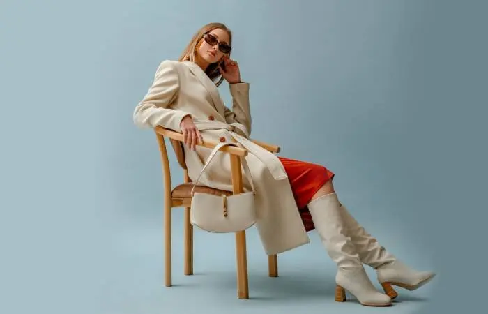 A woman in jeans and a fluffy coat paired with suede ankle boots