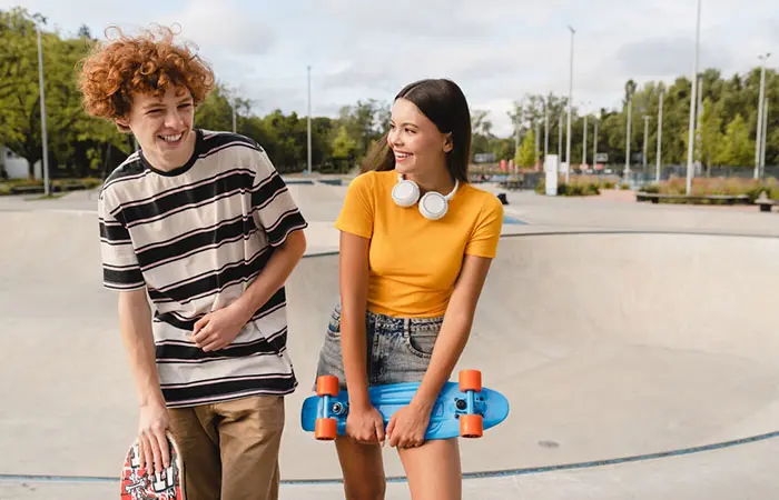 Cute teenage couple in a park