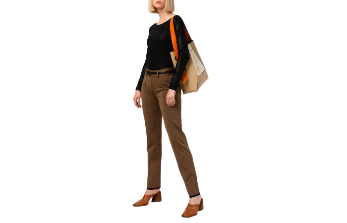 A woman wearing a fitted top with slacks and low heels