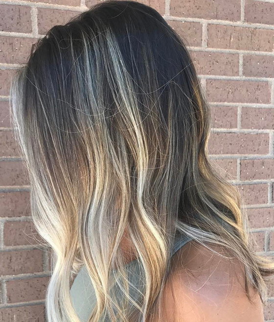 Naturally black hair dyed in neutral ash blonde hair color adds a pop of brightness