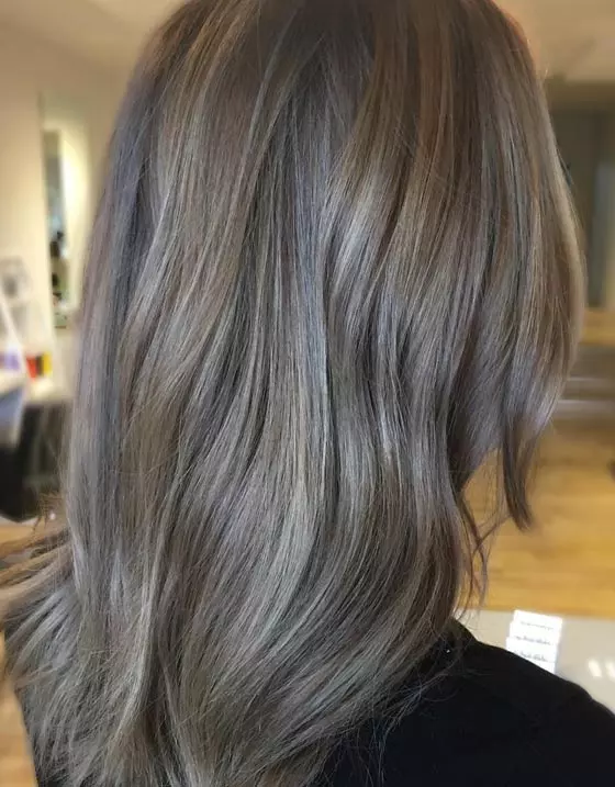 Cool toned brown lightened a few shades to create an in-between ash blonde hair color that falls between brown and blonde to make the ash bronde look