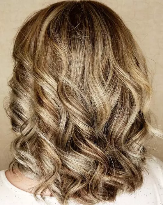 Brassy ash blonde hair color has stunning contrast from golden hair combined with the light ash blonde balayage highlights