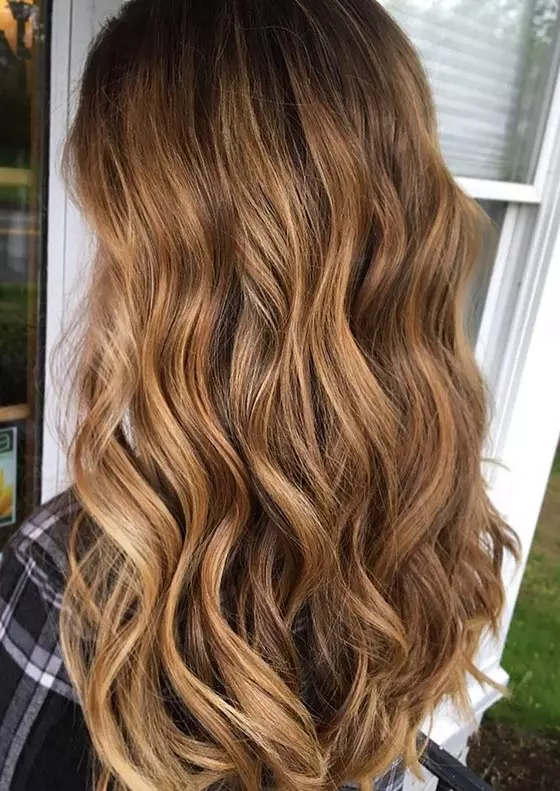 Bronze and honey blonde balayage hair color idea for wavy hair