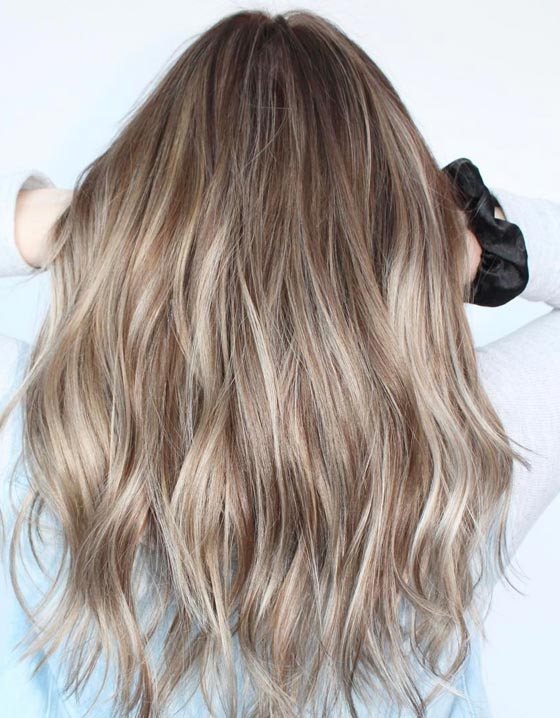 Buttery ash blonde highlighted with streaks of cool ash blonde hair color for a dynamic look