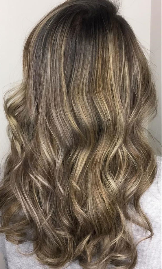 Golden and ash blonde hair color in balayage style imitates flaxen hair