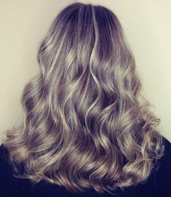 Gray balayage over medium ash blonde hair color creates a stunning look