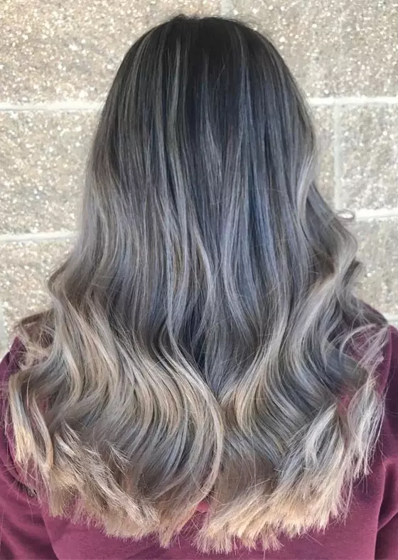 Long hair balayaged in ash blonde hair color and silver for a dynamic look