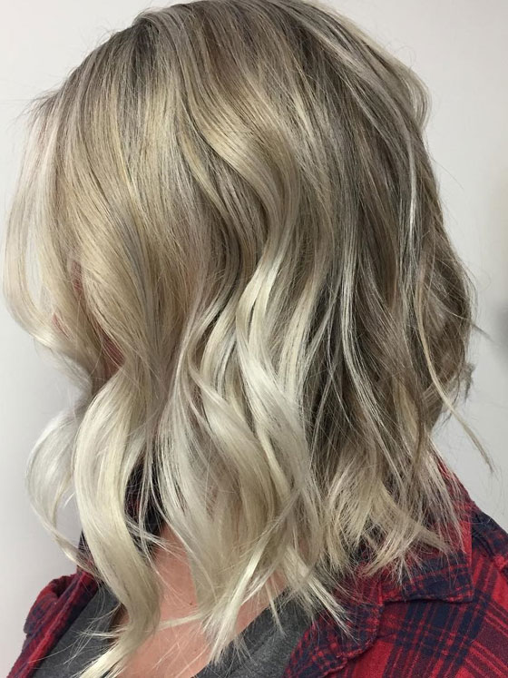 Long bob in a dark ash blonde near the roots with some silver ash blonde hilights at the ends.